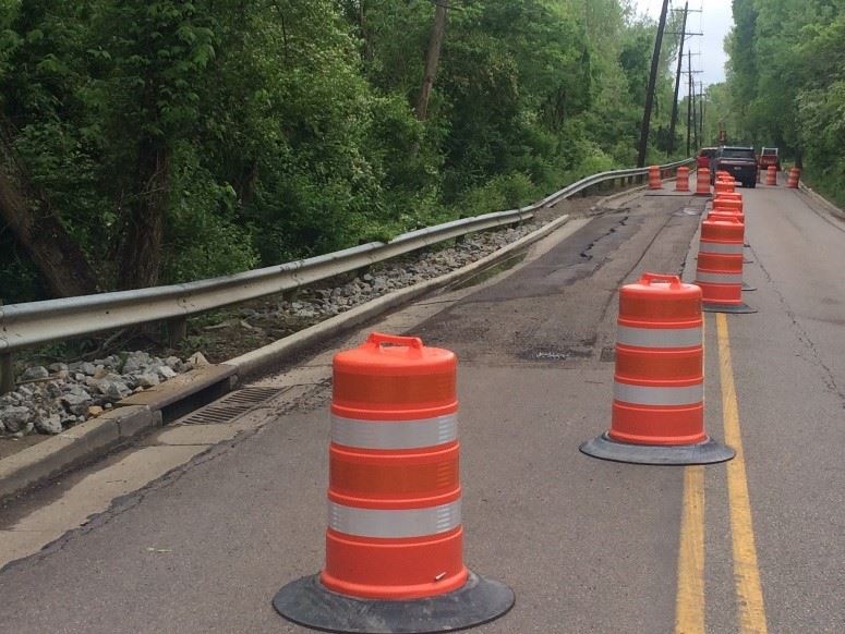 Orange construction barrels on road